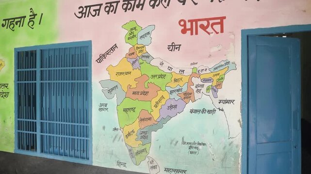 Full HD video of a hand-painted India map on a village school wall, showing states labeled in Hindi. Captures rural education, geography learning, and traditional classroom wall art in India.