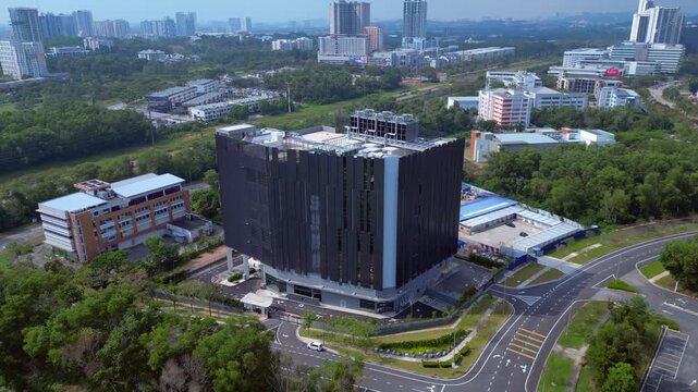 Huge data center Tower building, integrating advanced technology and infrastructure in a green environment. Lovely aerial view ascending raise up drone camera pointing down