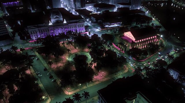 Night view of Recife with illuminated buildings reflecting on the river, showcasing the city&rsquo;s vibrant skyline, bridges, and urban energy after dark.