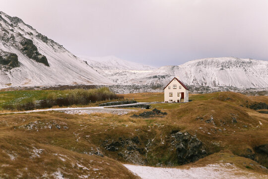 Winter mountain landscape with traditional house in Arnarstapi