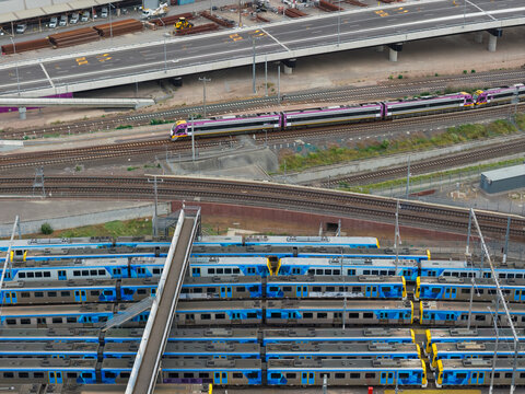 Rows of urban metro trains lined up in a railyard