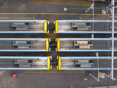 Rows of urban metro trains lined up in a railyard