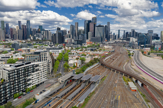 Suburban railway station and in front of a city skyline