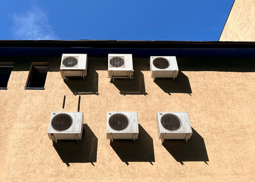 Air Conditioning Units on Building Wall Under Blue Sky on a Sunny Day