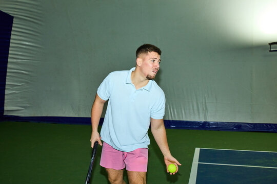 Man serves from the baseline