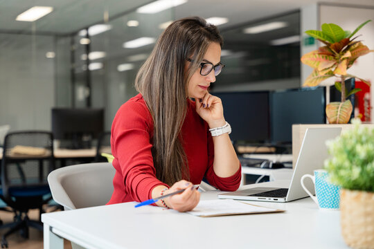 Woman working with laptop in modern office