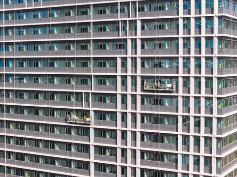 Workers Installing Facade on Modern Glass Office Building