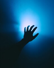 A minimalist symbolic image reflecting the influence of technology and screen addiction, depicting a child's hand reaching for light in the darkness.