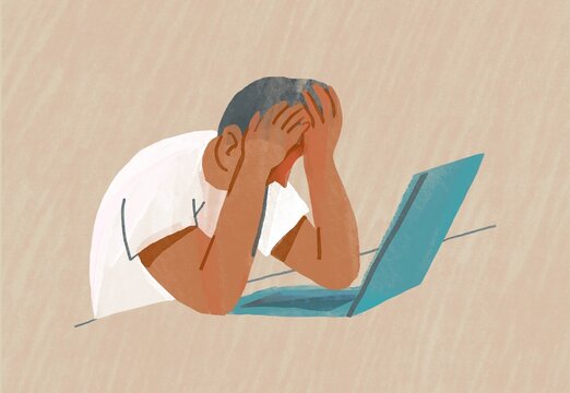 Stressed and Overworked: Man Leaning Over Laptop