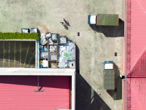 Aerial Factory Scrap Yard with Trucks and Workers