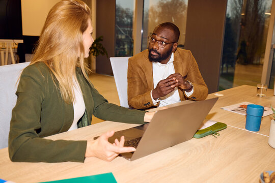 Man and a woman converse in the office