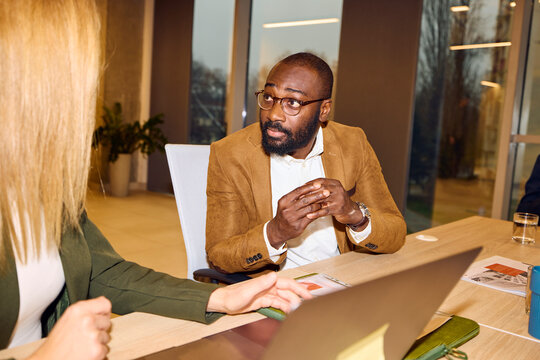 Man and a woman converse in the office