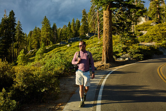 Man strolls down the scenic road in Yosemite