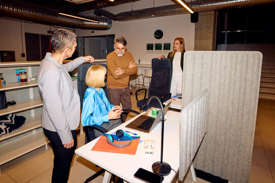 Colleagues talk in their shared workplace