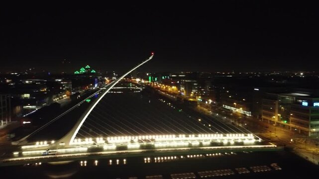 Night aerial view of urban lights and a bridge.