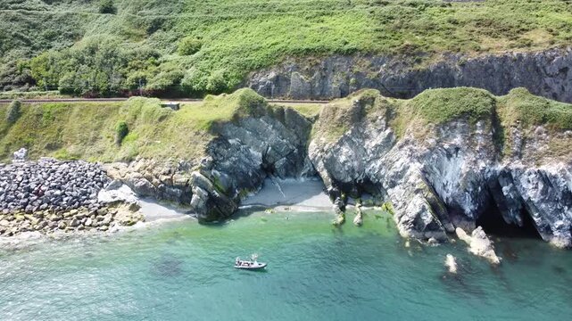 Small rocky bay with clear water viewed from above.