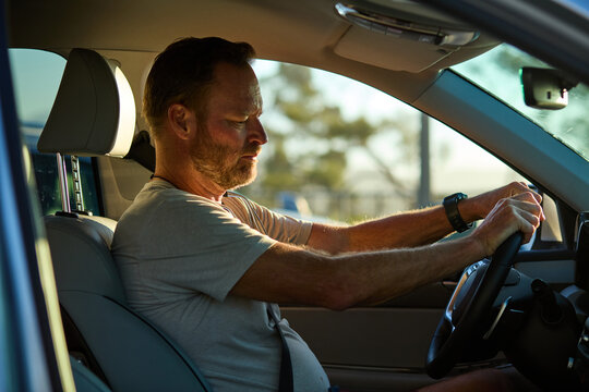 Man is sitting behind the wheel