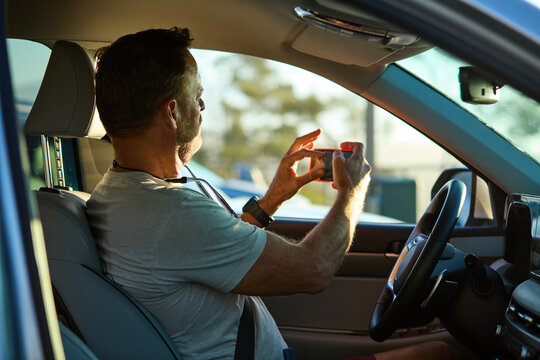 Man takes photos from a car
