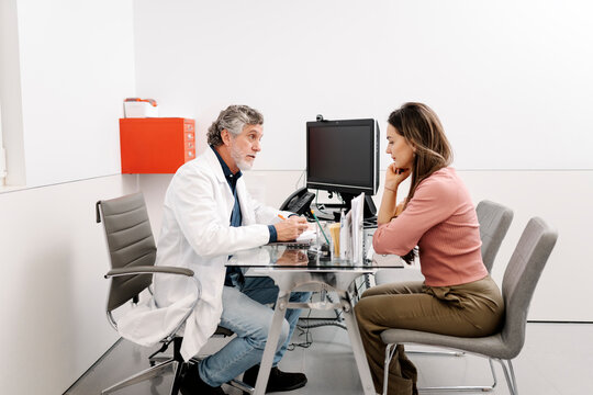 Doctor discussing medical information with patient in consultation