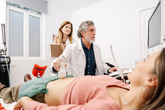 Gynecologist performing ultrasound consultation with patient