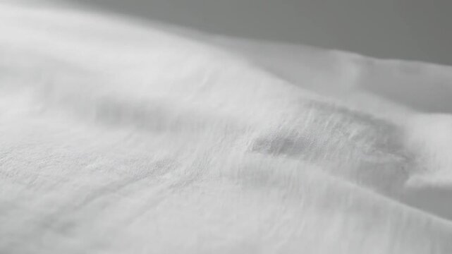 Close-up of White Fabric Texture with Gentle Ripples and Soft Lighting