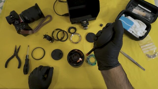 Applying specialized cleaning fluid to photography gear.