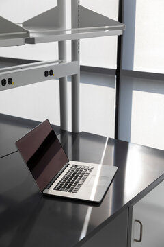 Laptop computer blank screen lab desk side view 