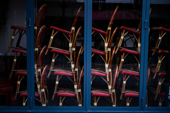 Stacked Chairs Seen Through a Glass Window at a Cafe