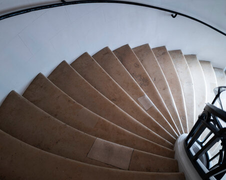 Spiral Staircase With Light and Shadow in a Building