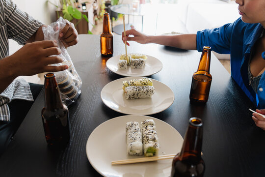 Friends eating sushi and beer
