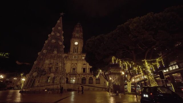 Wide night panorama of Porto's historic center decorated for Christmas.