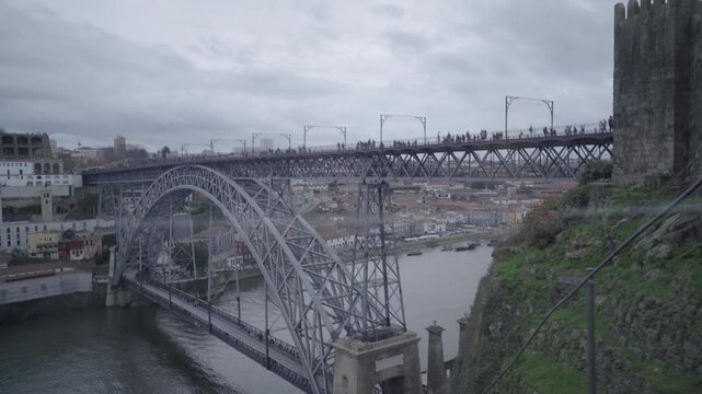 High angle view of the Dom Luis I Bridge upper deck with pedestrians.