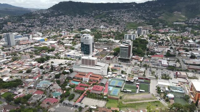 Tegucigalpa Honduras city center aerial drone footage showing dense Latin American capital with modern buildings, urban core, road grid and hillside neighborhoods in Central America.