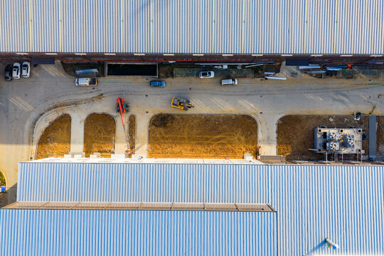 Top-Down View of Factory Yard with Construction Equipment

