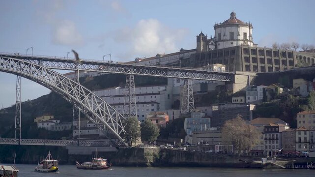 Side view of the iron bridge structure overlooking the river and the city.