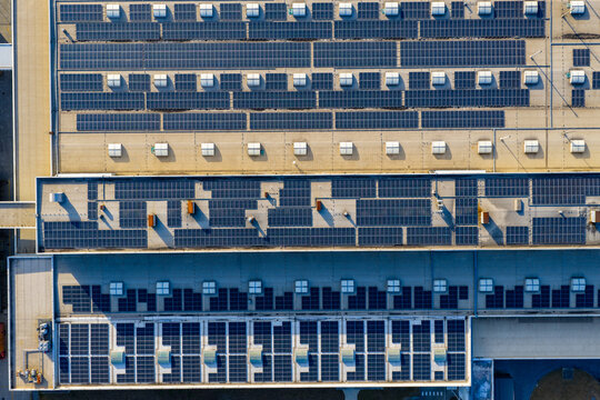 Top-Down View of Rooftop Solar Panels on Industrial Buildings

