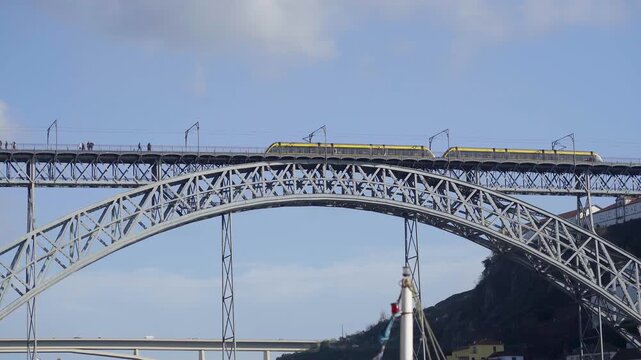 Close-up of the metallic arch of the Dom Luis I bridge against the sky.