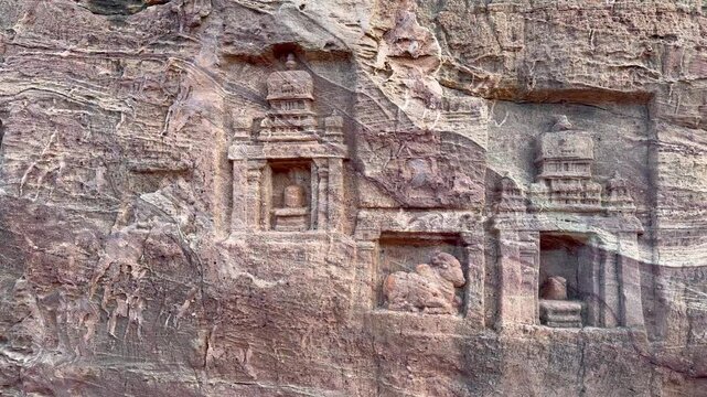 A striking Shiva Linga with Nandi, masterfully carved from red sandstone, set within a rock-cut temple, reflecting the grandeur and intricate artistry of Badami&rsquo;s Chalukyan architecture