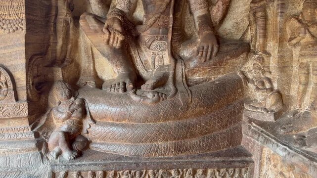 A serene Ananta-Shayana Vishnu stone carving from Badami Cave Temple No. 3, depicting Lord Vishnu reclining on Shesha, symbolizing eternal rest and cosmic order (Early Chalukya period)