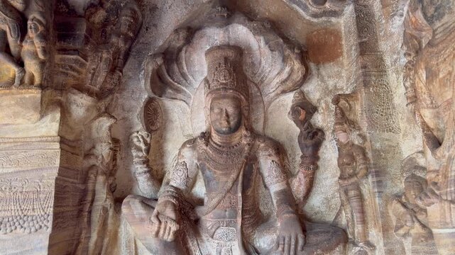 A serene Ananta-Shayana Vishnu stone carving from Badami Cave Temple No. 3, depicting Lord Vishnu reclining on Shesha, symbolizing eternal rest and cosmic order (Early Chalukya period).