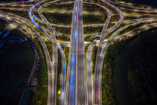 Aerial Night View of Complex Highway Interchange with Light Trails

