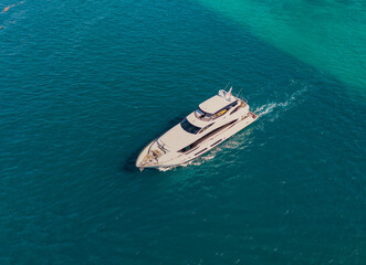 Fototapeta premium Boating and yachting. Luxury lifestyle. Marina yacht club. Yacht luxury view at sea. Vacation on summer. Summertime motorboat tour. Luxury motor boat yacht. Yacht go to marina. Marine journey