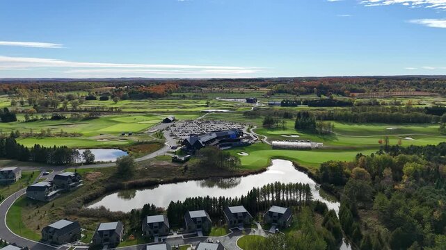 Drone shot of the landscape around TPC Toronto at Osprey Valley, Ontario, Canada. Lush green fairways blend into forest and open fields, emphasizing nature, space and a peaceful outdoor environment.