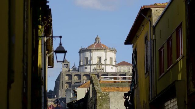 Another perspective of the Monastery framed by historic urban buildings.