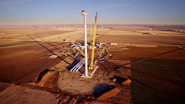 Aerial view of wind turbine construction across Illinois plains