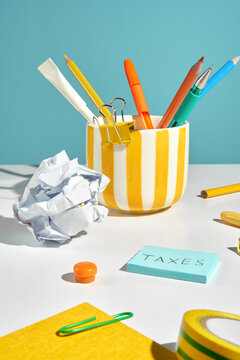 Colorful desk with stationery. A gentle reminder to pay taxes.