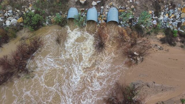 a creek with a water runoff after a heavy rain