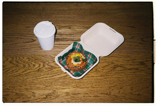 Freshly baked pastry in takeout box with coffee