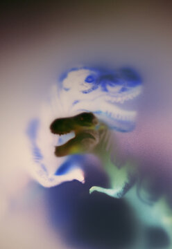 A dinosaur figure is shown with colorful effects