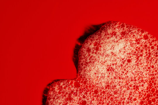 Bubbles Form in Red Liquid Under Bright Light Conditions